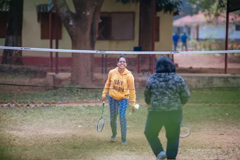Visitors playing badminton outdoors at Similipal