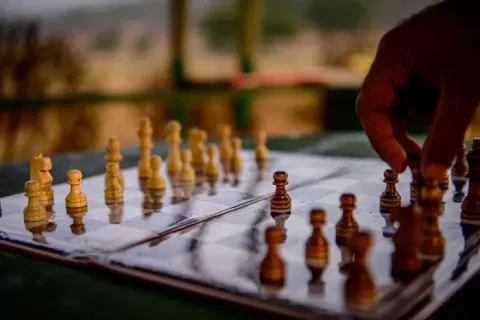 Visitors enjoying a chess game outdoors