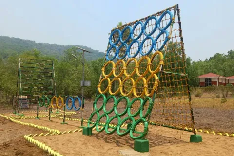 Green elevated adventure platform among forest trees
